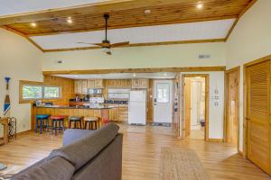 a living room with a couch and a kitchen at Waterfront Port Clinton Cottage with Fire Pit! in Port Clinton