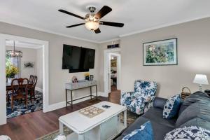 a living room with a couch and a ceiling fan at Blue Bungalow 2BR1BA Lexington in Lexington