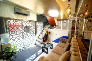a living room with a couch and a window at N.M. Hotel in Mumbai