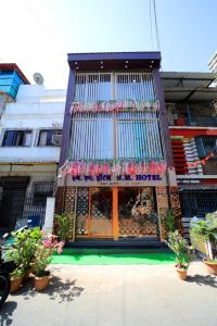 a building with plants in front of it at N.M. Hotel in Mumbai
