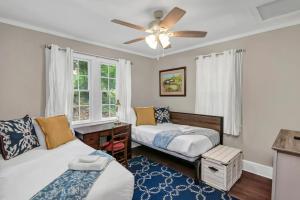 a bedroom with two beds and a ceiling fan at Blue Bungalow 2BR1BA Lexington in Lexington