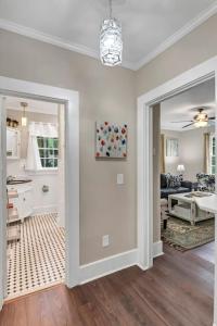 a living room with a door leading to a kitchen at Blue Bungalow 2BR1BA Lexington in Lexington