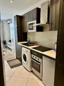 a kitchen with a washing machine and a washer at A007 Embassy Gardens Studio Apartm in Accra