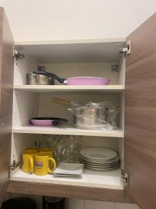 a cupboard with plates and utensils in a kitchen at OLD KRAKOV in Krakow