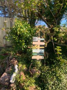 a wooden sign sitting in front of a tree at Ivy Lane in Loughanure