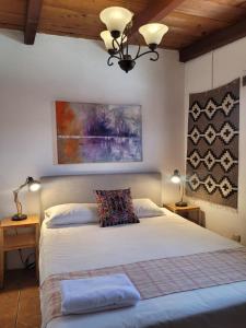 a bedroom with a bed with two pillows on it at 2 Pilas: historic colonial house in Antigua Guatemala