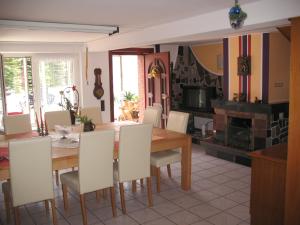 a kitchen and dining room with a table and chairs at Umichala in Mściszewice