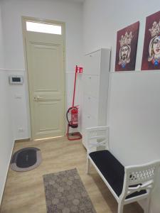 une chambre avec une porte, un banc et un aspirateur dans l'établissement Abitazione Del Mandorlo, à Trapani