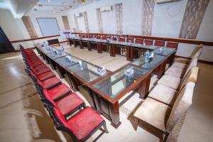 a long table and chairs in a room at Shelton House Peshawar in Peshawar