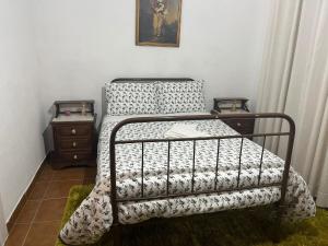 1 dormitorio con 1 cama con edredón blanco y negro en Vivenda Barros, en Anadia