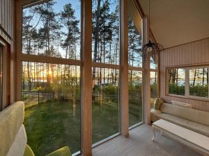 a living room with large windows and a couch at River bank vacation home in Jūrmala