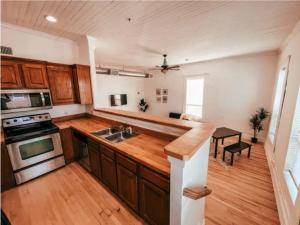 a kitchen with a sink and a stove at The Yellowrose in Waxahachie