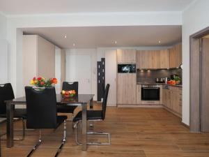 - une cuisine et une salle à manger avec une table et des chaises dans l'établissement Holiday apartment 2-room apartment with 1 bedroom and terrace DG22, à Heringsdorf