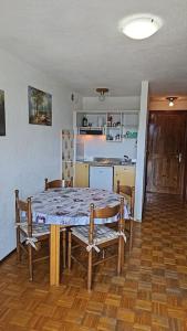 a table and chairs in a room with a kitchen at La casa di, Sara Morgex in Morgex +12 photos