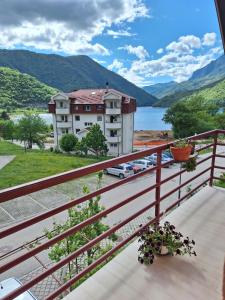 a balcony with a view of a building and a lake at Apartmani Lena in Plužine