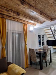 a living room with a table and chairs at Apartmani Lena in Plužine