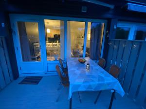 a blue table on a porch at night at Hällestrand Apartment 32 in Strömstad +16 photos