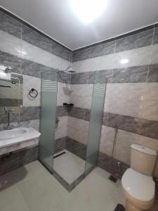 a bathroom with a shower and a toilet and a sink at Dream Garden Luxor in Luxor +85 photos
