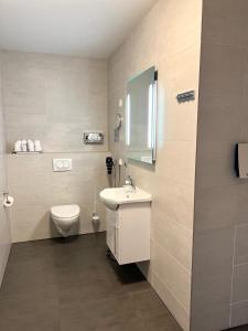 a bathroom with a toilet and a sink at Lónið Apartments in Höfn
