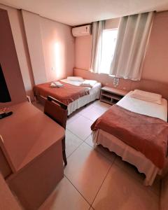 Giường trong phòng chung tại Gravata Praia Hotel - Frente Mar