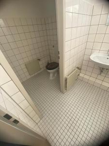 a bathroom with a toilet and a sink at Kapitän Dallmann str.14 in Bremen