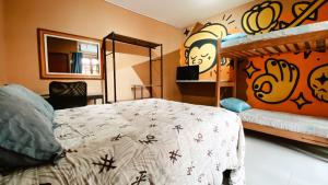 a bedroom with a bed and a bunk bed at Sagui Hostel in Florianópolis