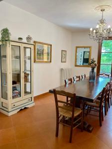 a dining room with a wooden table and chairs at Villa Elisa in Scarperia