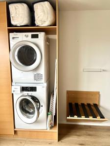 a washing machine and a washer and dryer in a room at Lónið Apartments in Höfn