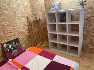 a bedroom with a bed and a book shelf at Studio Cosy Mezzanine in Talence