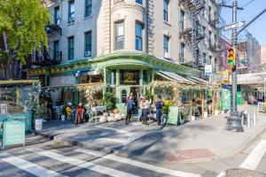 a group of people walking down a city street at West Village 3br w wd nr Pier 46 NYC-1098 in New York