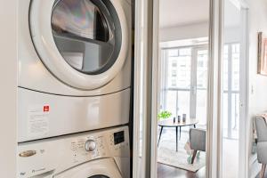 a washer and dryer in a living room at 300 Front Suites in Toronto