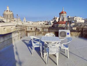 a table and chairs sitting on top of a roof at Traditional Maltese Townhouse in Rabat in Rabat