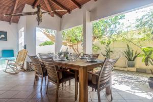 a dining room with a wooden table and chairs at Cas Amigos Villa in Palm-Eagle Beach