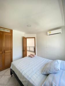 a bedroom with a large bed and a window at Edificio el peñon in Santa Marta +139 photos