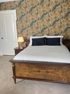 a bedroom with a bed with a wallpaper with fishes at Noan Country House B&B in Cashel