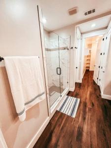 a bathroom with a shower and a glass shower backdoor at Buffalo Creek Loft Downtown in Waxahachie +19 photos