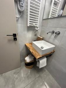 a bathroom with a white sink and a mirror at Filia Skyros Suites in Skiros