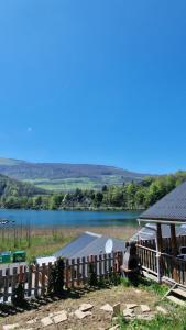 a house with a view of a lake at Chalet bord de lac avec piscine 2A in Laffrey