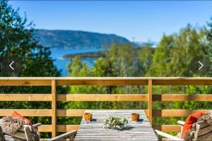 a picnic table with a view of the water at Beautiful Cabin by Mjøsa. in Stange