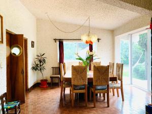 a dining room with a table and chairs at Villa Colorines in Tepoztlán