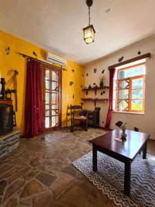 - un salon avec une table et une cheminée dans l'établissement Spitia Katoi, à Paleóchora
