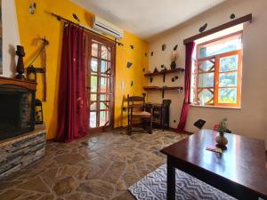 a living room with a fireplace and a tv at Spitia Katoi in Palaiochora