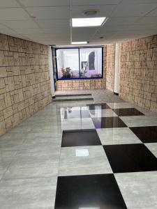 an empty room with a checkered floor and windows at SIMA Suite Unit 6 in Ashdod