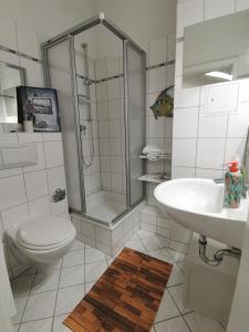 uma casa de banho com um chuveiro, um WC e um lavatório. em Have a nice home em Leipzig
