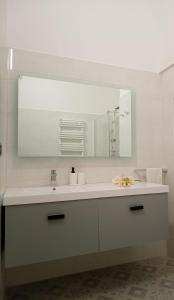 a bathroom with a sink and a large mirror at Splendore del Sole in Polignano a Mare +29 photos