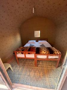 a bedroom with a bed in a room at Desert Dream Camp in Wadi Rum