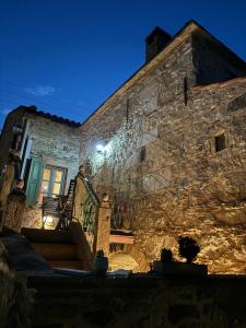 a stone building with a staircase in front of it at Irene's Mansion in Vrontados