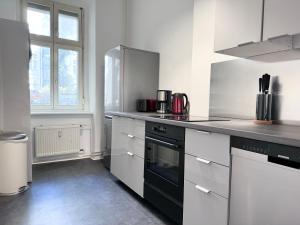 a kitchen with a black and white counter top at Be in Berlin Apartments at Charlottenburg Castle in Berlin