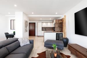 sala de estar con sofá y TV en Spacieux appartement de 114 m2 à 5 min des plages - proximité tous commerces et transports en Antibes