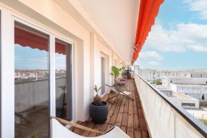 balcón con sillas y vistas a la ciudad en Spacieux appartement de 114 m2 à 5 min des plages - proximité tous commerces et transports, en Antibes